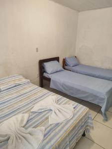 two beds in a room with two bedsvisor at Pousada Encantos de Maceió in Maceió