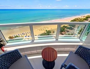 a view of the beach from the balcony of a condo at Flat Radisson Recife in Recife
