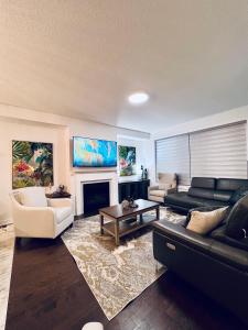 a living room with a couch and a fireplace at Brand New! Modern Luxury Retreat! in Barrie
