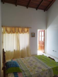 A bed or beds in a room at Tu Hogar en la Tierra del Cacao