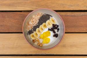 a bowl of food with bananas and chocolate chips at Maya Papaya in Antigua Guatemala +27 photos