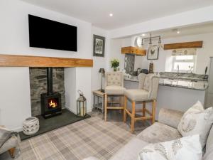 a living room with a fireplace and a stove at 9 Chapel Street in Conwy