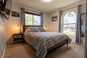 a bedroom with a large bed and a window at Montage - A Birdy Vacation Rental in Schertz