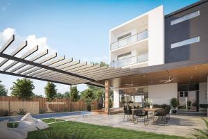 a modern house with a patio with a table and chairs at The Beach Oasis ~ Dune in Kingscliff
