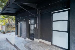 a black building with two large windows on it at Studios do Vale 1 in São Paulo