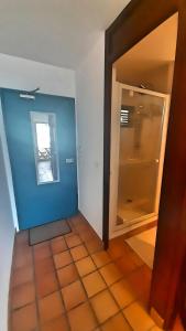 a room with a blue wall and a glass door at Suite du Moqueur Gorge Blanche in La Trinité