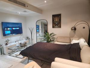a living room with a couch and a glass table at Sea View 1BR Al Raha Beach in Abu Dhabi