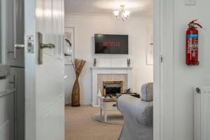 a living room with a couch and a fireplace at Spacious Apartment with Parking! in Jesmond