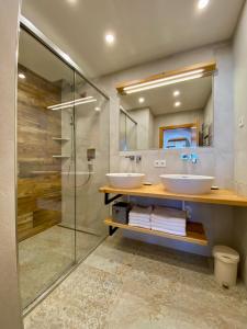 a bathroom with two sinks and a glass shower at Haus Plattenkar in Obertauern +27 photos