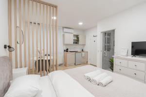 a bedroom with a white bed with pillows on it at Classy & Cozy apartment 2 in Ljubljana