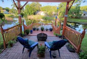 a gazebo with two chairs and a fire pit at Harmony Bed and Breakfast Private Queen GardenviewRoom in Lutz