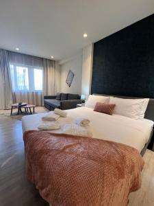 a bedroom with a large bed and a couch at Athenian Retreat Penthouses in Athens