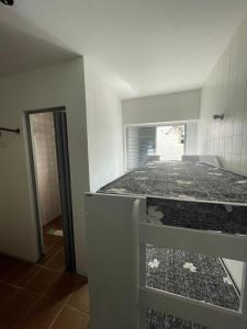 a room with a bed in a room with a window at Hospedagem Riccetti´s - Consulado Americano in Sao Paulo