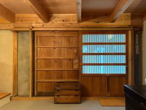 Cette chambre dispose d'une porte en bois et d'une fenêtre. dans l'établissement The Bath & Bed Obuse - Vacation STAY 15924, à Obuse