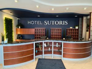a hotel lobby with a hotel sylords sign on the wall at Hotel Sutoris in Bochnia