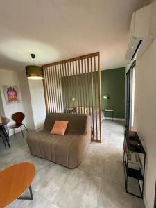 un salon avec un lit et une table dans l'établissement Grand Studio moderne tout confort, à Porto-Vecchio