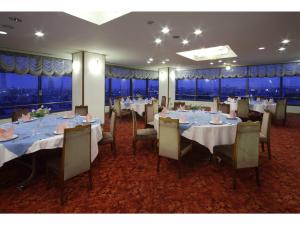 a dining room with tables and chairs with a view at Hotel New Yutaka - Vacation STAY 35263v in Izumi-Sano