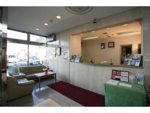 a lobby with a waiting room with a couch and a counter at Hotel New Yutaka - Vacation STAY 35263v in Izumi-Sano