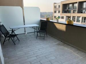 a balcony with a table and chairs on a building at Sofia & Natalia apartament in Bucharest