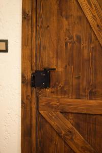 a wooden door with a black knocker on it at Chateaux Constantin Agistro in Angistron