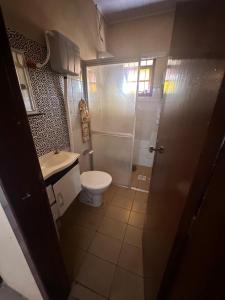 a bathroom with a toilet and a sink and a shower at Casa albatroz Imbé in Imbé +11 photos