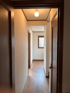 an empty hallway with a hallway leading into a room at Hoshi no Machi No, 177 - Vacation STAY 39992v in Tsumagoi