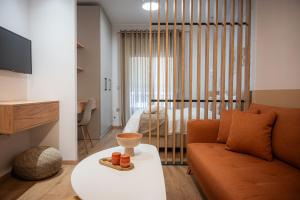 a living room with a couch and a table at White Luxury Apartments in Katerini