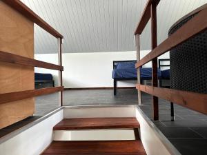 a staircase in a room with two bunk beds at Maison Moehau Iti in Moorea