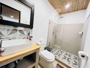 a bathroom with a sink and a toilet and a shower at Nirvana Beach Home in Paraíso
