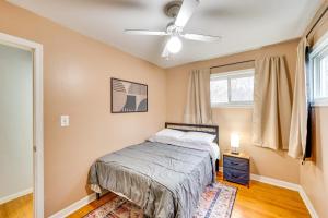 een slaapkamer met een bed en een plafondventilator bij Milwaukee Home with Fenced Yard 9 Mi to Downtown! in Milwaukee