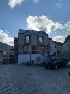 a house with a car parked in front of it at Casa da Carvalha - Loriga in Loriga