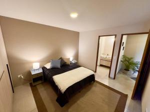 a bedroom with a bed and a large mirror at Casa Acento by Cosmos Homes in Querétaro