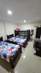 a room with three beds in a room at Hotel Barranquilla Inn in Barranquilla