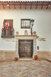 a building with a fireplace with flags on it at Hotel Sol de Belén Cajamarca in Cajamarca