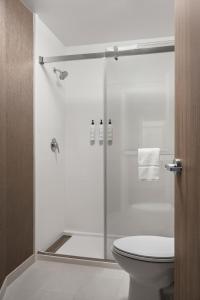a bathroom with a glass shower with a toilet at SpringHill Suites by Marriott Chicago Bolingbrook in Bolingbrook