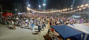 a large crowd of people at an event at night at Cuestas Del Búho Casa Serrana in Agua de Oro +28 photos