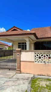 a house with a gate and a fence at AF HOMESTAY in Dungun