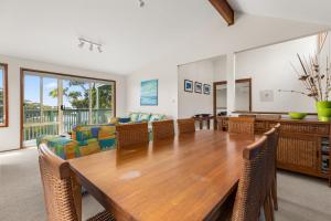 a dining room with a wooden table and chairs at Daybreak by Experience Jervis Bay in Vincentia