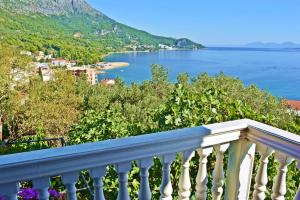 a balcony with a view of a body of water at Apartments Cosic in Igrane +15 photos