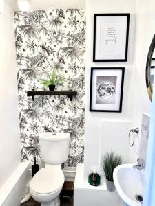 a bathroom with a toilet and a sink at Historic Charm: *Perfect For Group Getaways* in Trowbridge