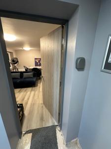 a door leading into a room with a living room at NEW HAVEN APARTMENTS IN THE CENTRE. in Boston