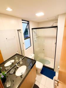 a bathroom with a sink and a shower and a toilet at Muro Alto-Porto de Galinhas Flat Makia 104D in Ipojuca