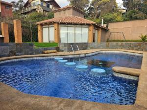 una piscina en un patio con una casa en Espectacular Bahía Bonita depto 22 en Concón