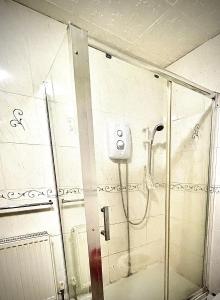 a shower in a bathroom with a glass door at Inviting 2-Bed House in Birmingham in Birmingham