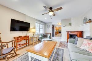 a living room with a couch and a fireplace at Tranquil Ogunquit Condo Walk to Beach and Marina! in Ogunquit