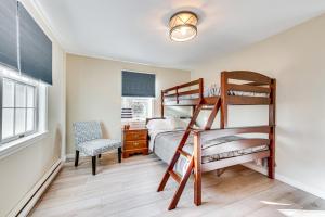 a bedroom with two bunk beds and a desk at Tranquil Ogunquit Condo Walk to Beach and Marina! in Ogunquit