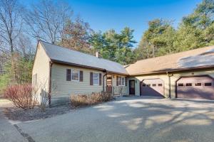 a house with a garage and a driveway at Tranquil Ogunquit Condo Walk to Beach and Marina! in Ogunquit