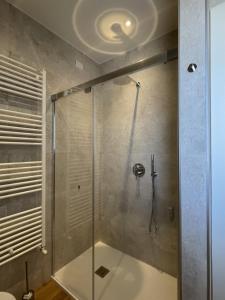 a bathroom with a shower with a glass door at Mari'Entu in Quartu SantʼElena