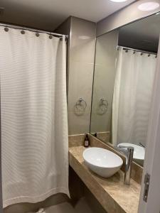 a bathroom with a sink and a shower curtain at Villa Ángela in Posadas