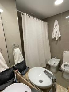 a bathroom with a sink and a toilet at Villa Ángela in Posadas